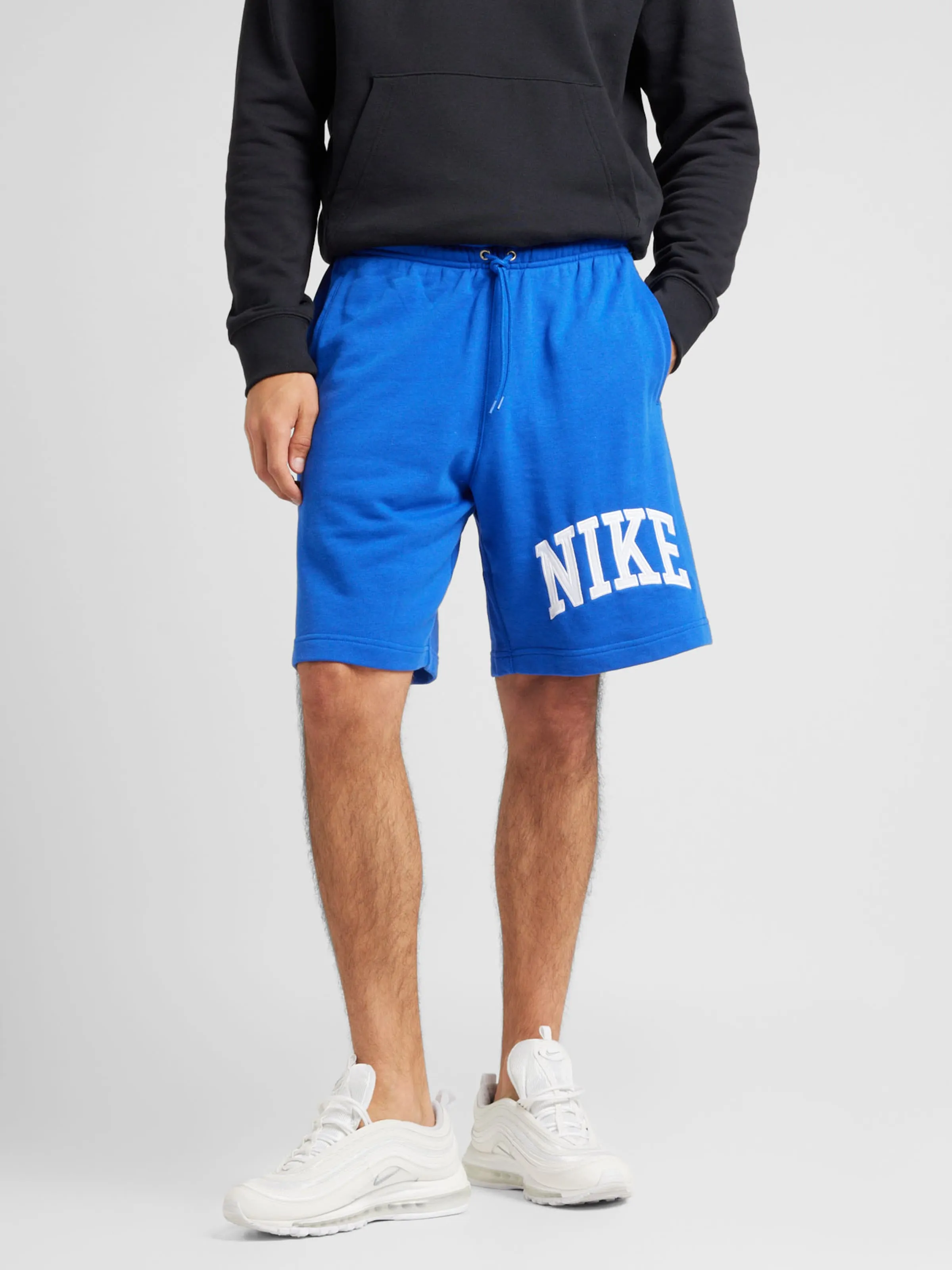 Loosefit Pantalón 'CLUB' Nike Sportswear en Azul Real